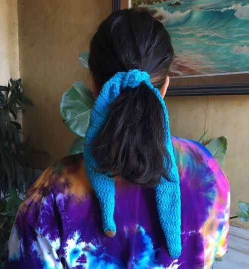 Mujer mostrando cola recogida con pañuelo de crochet