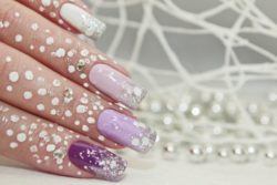 Uñas color pastel largas lilas con perlas y purpurina